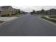 View of street in a suburban neighborhood with well maintained lawns at 400 Watusi Way, St Cloud, FL 34772