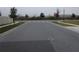 Street view of a quiet neighborhood corner with lush landscaping at 400 Watusi Way, St Cloud, FL 34772
