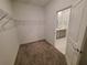 Walk-in closet with carpet flooring, white shelves and bathroom entrance at 400 Watusi Way, St Cloud, FL 34772