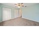 Bedroom featuring ceiling fan, carpet and large closet at 4629 Nw 30Th Pl, Ocala, FL 34482