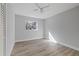 Simple bedroom with light walls, new flooring, and a window at 5525 Tillman Rd, Lakeland, FL 33810