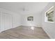 Well-lit bedroom featuring new flooring and a closet at 5525 Tillman Rd, Lakeland, FL 33810