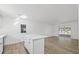 Open concept kitchen and living area with new flooring and sliding doors at 5525 Tillman Rd, Lakeland, FL 33810