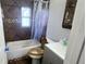 Bathroom with shower/tub combo, grey vanity, and tile flooring at 1650 Pine Ave, Mount Dora, FL 32757