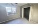 Spacious bedroom with grey walls, carpeting, and a closet at 1650 Pine Ave, Mount Dora, FL 32757