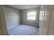 Simple bedroom with grey walls and carpeting at 1650 Pine Ave, Mount Dora, FL 32757