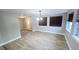 Dining area with wood-look tile floor, and view into living area at 1650 Pine Ave, Mount Dora, FL 32757