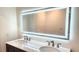 Elegant bathroom with a double vanity, backlit mirror, and modern fixtures at 3720 Willis Rd, Mulberry, FL 33860