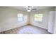 Well-lit bedroom with two windows and wood-look floors at 3720 Willis Rd, Mulberry, FL 33860