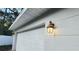 White garage door with exterior lighting at 3720 Willis Rd, Mulberry, FL 33860