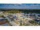 This aerial showcases the community, filled with homes amidst lush trees and tidy streets at 8779 Fort Socrum Village Way, Lakeland, FL 33810