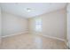 A spacious bedroom with a neutral palette featuring tile floors and a window at 8779 Fort Socrum Village Way, Lakeland, FL 33810