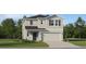 Two-story house with a two-car garage, shutters, and a landscaped lawn at 922 Hour Glass Rd, Lakeland, FL 33801