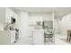 Modern white kitchen with stainless steel appliances and an island at 922 Hour Glass Rd, Lakeland, FL 33801