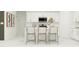 White kitchen with an island and three barstools at 922 Hour Glass Rd, Lakeland, FL 33801