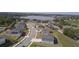 Aerial view of a neighborhood showcasing well-maintained homes, sidewalks, and proximity to a lake at 930 Fieldstone Way, Haines City, FL 33844