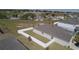 Aerial view showcasing the home's backyard, surrounded by a white fence and green grass at 930 Fieldstone Way, Haines City, FL 33844