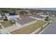 Aerial view of a single-story gray home with manicured lawns, street view at 930 Fieldstone Way, Haines City, FL 33844