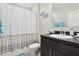 Bathroom with black countertop vanity, toilet, and tub with a shower curtain at 930 Fieldstone Way, Haines City, FL 33844