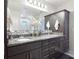Bathroom with double vanity, granite countertops, and decorative tiling at 930 Fieldstone Way, Haines City, FL 33844