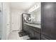 Well-lit bathroom with double vanity, granite countertops, and tile flooring at 930 Fieldstone Way, Haines City, FL 33844