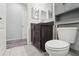 Bright bathroom with tiled floor, dark cabinets, and modern fixtures at 930 Fieldstone Way, Haines City, FL 33844
