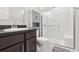 Modern bathroom with a glass-door shower, stylish vanity, and a wall-mounted cabinet at 930 Fieldstone Way, Haines City, FL 33844