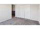 Carpeted bedroom features a closet and access to a sink and cabinets at 930 Fieldstone Way, Haines City, FL 33844