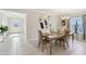 Elegant dining room with tile floors, a decorative mirror, and natural light from the window at 930 Fieldstone Way, Haines City, FL 33844