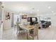 Bright dining area with tile floors, neutral decor, and a view into the adjacent living room space at 930 Fieldstone Way, Haines City, FL 33844