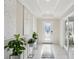 Bright entryway with tile flooring, decorative plants, and a decorative front door at 930 Fieldstone Way, Haines City, FL 33844