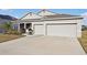 Charming single-story home featuring a well-manicured lawn and a two-car garage at 930 Fieldstone Way, Haines City, FL 33844