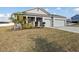 A single-story gray home with a manicured lawn and a two-car garage at 930 Fieldstone Way, Haines City, FL 33844