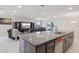 Stylish kitchen featuring a granite island, modern cabinetry, and an open layout to the living area at 930 Fieldstone Way, Haines City, FL 33844