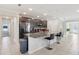 Contemporary kitchen featuring a granite island with bar seating and stainless steel appliances at 930 Fieldstone Way, Haines City, FL 33844