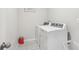 Laundry room with washer, dryer, tile floor, and accessories at 930 Fieldstone Way, Haines City, FL 33844