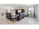 Spacious living room featuring tile flooring, a large TV, and elegant decor with a dining area view at 930 Fieldstone Way, Haines City, FL 33844