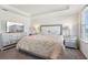 Beautiful bedroom featuring a large bed with a luxurious comforter, two lamps and nightstands at 930 Fieldstone Way, Haines City, FL 33844