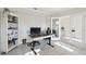 Bright office with white shelving, decorative desk, and glass french doors at 930 Fieldstone Way, Haines City, FL 33844