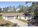 Single-story home with a large backyard and mature trees at 135 Country Club Ln, Mulberry, FL 33860