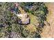 Top-down view of a house nestled among lush greenery at 135 Country Club Ln, Mulberry, FL 33860