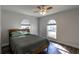 Cozy bedroom with a queen bed and wood-look floors at 135 Country Club Ln, Mulberry, FL 33860