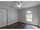 Charming bedroom with wood-look floors and an arched window at 135 Country Club Ln, Mulberry, FL 33860