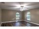 Bright bedroom with two arched windows and wood-look floors at 135 Country Club Ln, Mulberry, FL 33860