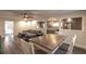 Open dining area with wood table, gray sectional sofa, and hardwood floors at 135 Country Club Ln, Mulberry, FL 33860