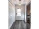 Bright entryway with white doors and grey wood-look floors at 135 Country Club Ln, Mulberry, FL 33860