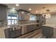 Spacious kitchen with stainless steel appliances, farmhouse sink, and gray cabinetry at 135 Country Club Ln, Mulberry, FL 33860