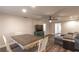 Living room with gray sectional sofa, wood dining table and hardwood floors at 135 Country Club Ln, Mulberry, FL 33860