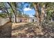 Large, private backyard with mature trees and a white privacy fence at 18 Pine Circle Dr, Ocala, FL 34472