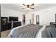 Bedroom with a large bed, dark wood furniture, ceiling fan and carpet flooring at 18 Pine Circle Dr, Ocala, FL 34472